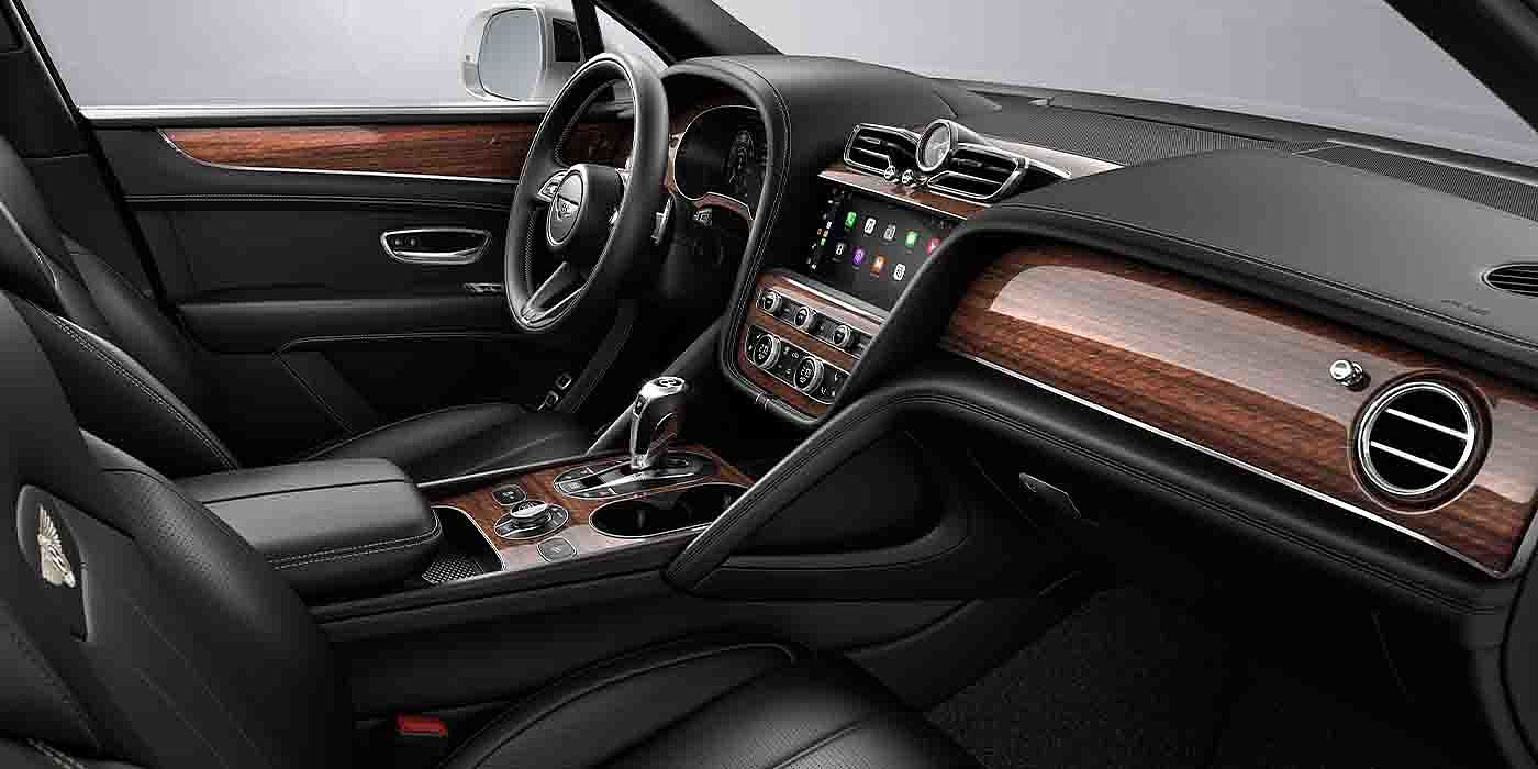 Bentley Jiaxing Bentley Bentayga EWB interior with a Crown Cut Walnut veneer, view from the passenger seat over looking the driver's seat.